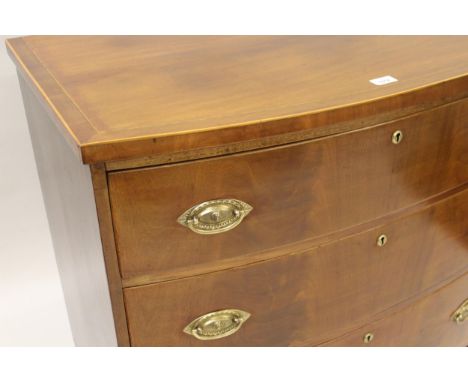 19th Century mahogany bow fronted chest of three graduated long drawers with oval brass handles and splay bracket feet, 35.5i