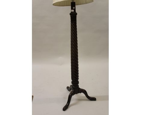 Early 20th Century wrought iron lamp standard, mahogany bed post lamp standard, an oval mahogany bevelled edge wall mirror an