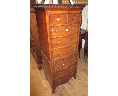 Mahogany serpentine fronted tallboy having two short drawers above six long drawers, with brushing slide and brass handles (a