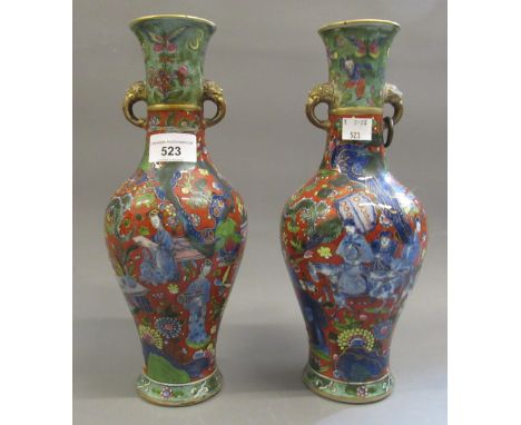 Pair of Chinese porcelain baluster form vases, with elephant mask head handles, painted with figures and clobbered decoration