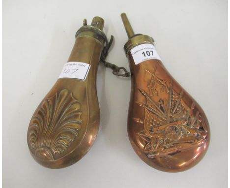 Copper powder flask embossed with military arms, together with a similar brass flask 