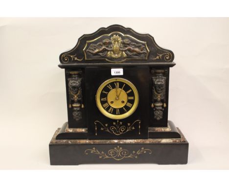 Large 19th Century black slate gilt metal mounted mantel clock, the black enamel dial with gilded Roman numerals and a two tr