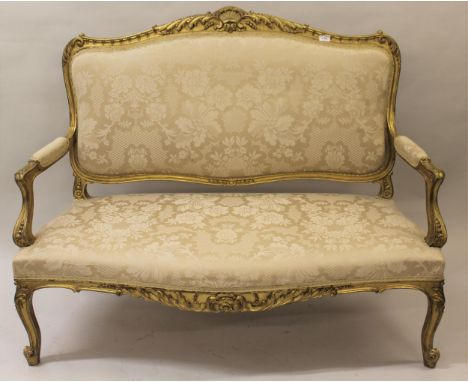 19th Century French giltwood two seater sofa upholstered in gold damask, on cabriole front supports 