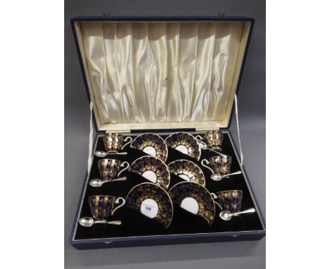 Cased set of six Aynsley porcelain coffee cups and saucers with gilded decoration on blue ground, together with a set of six 