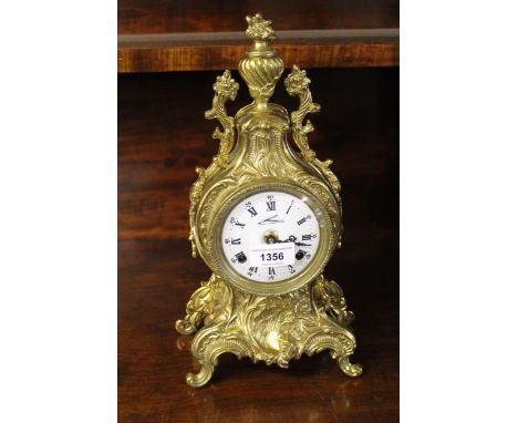 Reproduction brass mantel clock, the enamel dial with Roman and Arabic numerals, with a two train movement striking on bells,