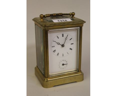 20th Century brass cased two train carriage clock with alarm function, having enamel dial with Roman numerals, subsidiary ala