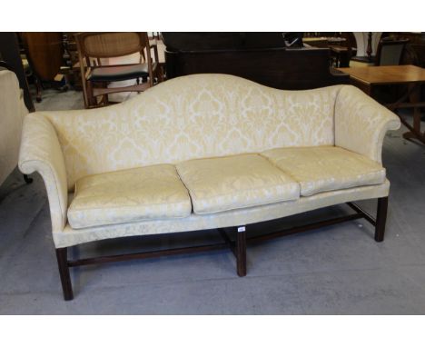 George III hump back sofa upholstered in figured yellow silk damask, raised on square cut chamfered supports with stretchers,