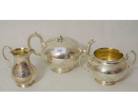 Victorian silver three piece tea service of engraved circular squat baluster form, the tea pot and cream jug hallmarked Londo