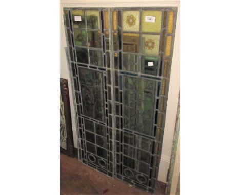 Pair of late 19th Century coloured and stained leaded glass door panels with floral decoration and bulls eyes, 40ins x 10.25i