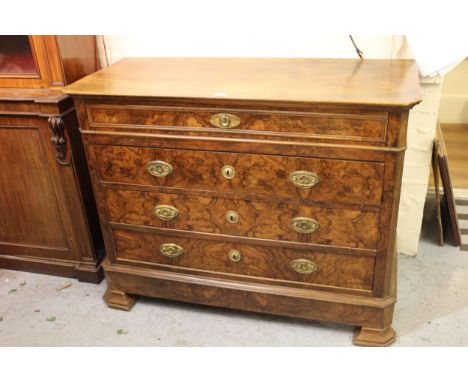 19th Century French walnut commode of four long graduated drawers with oval brass handles, raised on bracket feet, 48ins x 21