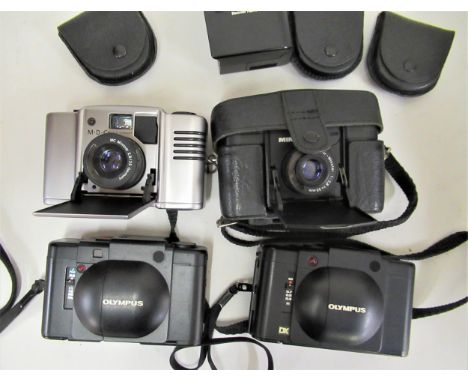 Two Olympus XA cameras together with two Minox cameras and a small quantity of accessories 