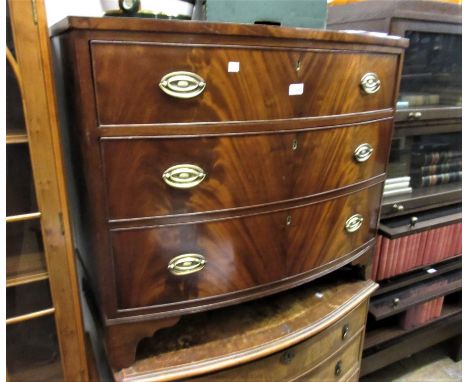 19th Century mahogany bow fronted chest of three long graduated drawers with oval brass handles, raised on bracket feet 