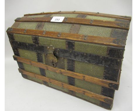 A doll's early 20th Century wooden and metal banded dome top trunk with part fitted interior 