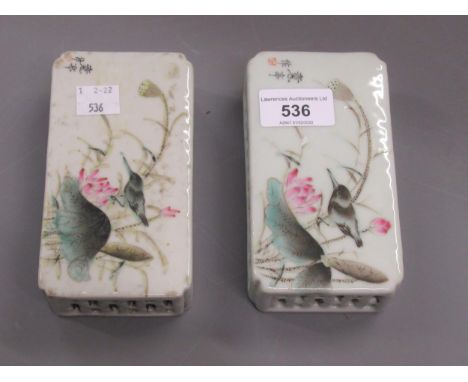 Two Chinese scroll weights, with pierced borders, decorated in enamel with birds and flower, bearing character mark signature