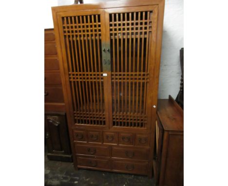 20th Century oriental hardwood side cabinet with a pair of lattice work doors, enclosing shelves above an arrangement of nine