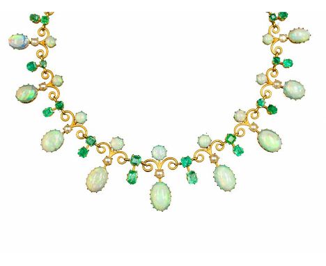 A Liberty & Co opal emerald and seed pearl set fringe necklace, circa 1900, the yellow gold scroll work front comprising elev