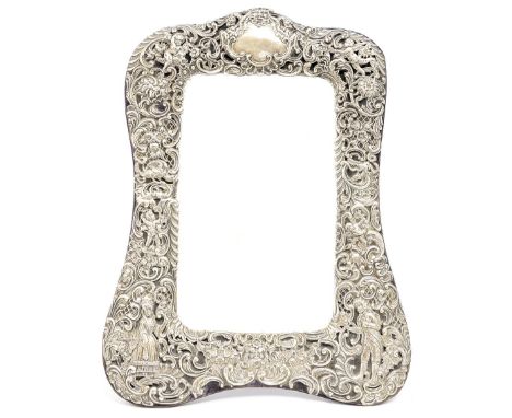 An Edwardian silver chased table easel mirror, London 1902, the surround cast with Rococo scrolled decoration and a vacant ca