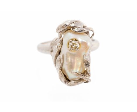 An 18ct white gold baroque pearl and diamond set designer ring, the organic design with wrap around leaf design setting to ce