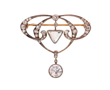 An early 20th century Art Nouveau design diamond drop brooch, the round old cut diamond drop weighing approx 1.50 carats, ass