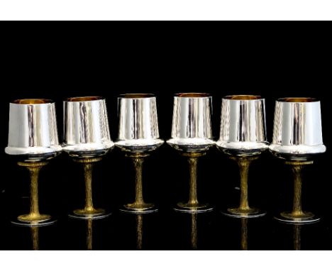 A set of six contemporary English silver goblets, modelled in the style of Stuart Devlin, each atop a waisted silver gilt and