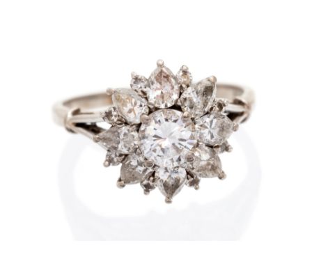 A diamond flower head cluster ring, the centre round brilliant-cut diamond approx 0.75 carat, assessed colour H/I, assessed c