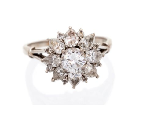 A diamond flower head cluster ring, the centre round brilliant-cut diamond approx 0.75 carat, assessed colour H/I, assessed c