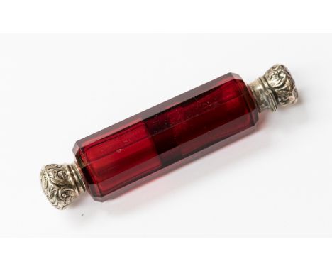 A 19th Century ruby glass double ended scent bottle, slice cut cylinder form with embossed white metal foliate ends 