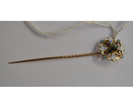 An enamel stick pin, open work finial set to the centre with a star stone, unmarked  9ct gold with white, blue and black enam