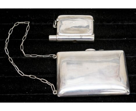 An early 20th Century possibly American plain silver vanity coin case, the interior with cigarette folder, two coin holders a