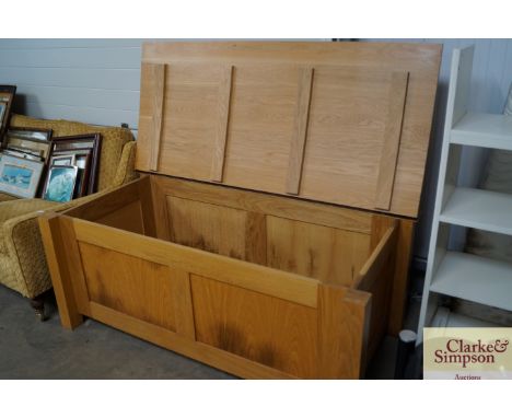 A large light oak ottoman 