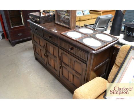 An Ercol style sideboard fitted three drawers