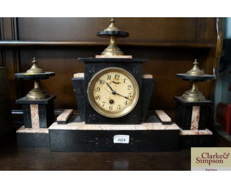 An Art Deco black slate and marble clock with garnitures