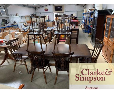 An Ercol extending dining table and six chairs including two carvers 