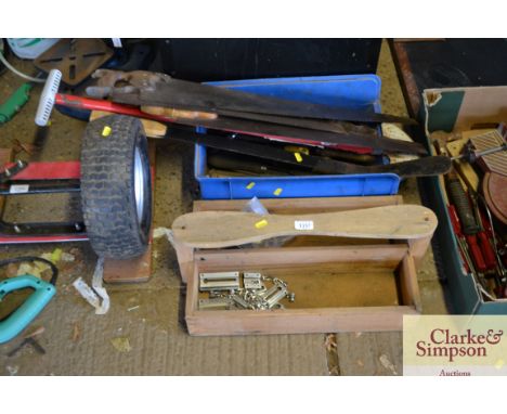 A wooden tool box and plastic tool box containing various hand tools and hand saws