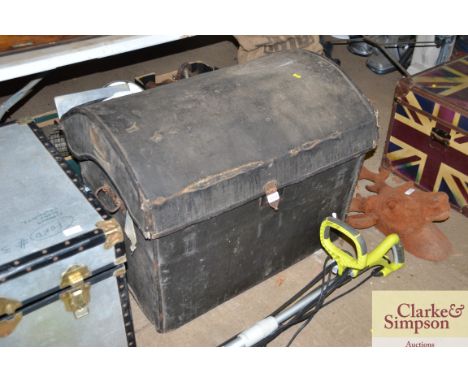 A leather and canvas dome topped trunk