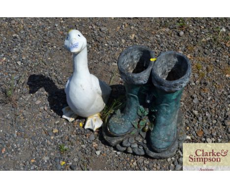 A garden planter in the form of boots and a garden ornament in the form of a goose