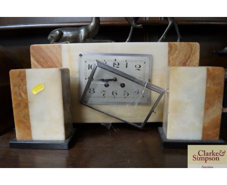 An Art Deco onyx and marble decorated with two deer and having garnitures mantel clock