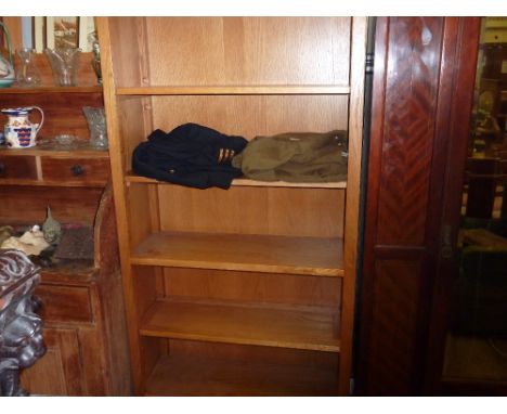 A light oak bookcase fitted single drawer below 