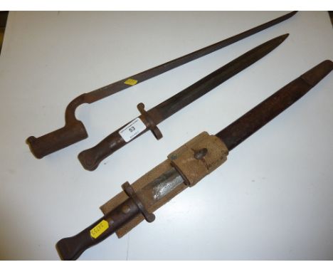 A Victorian bayonet in metal scabbard and webbing; together with one other bayonet similar; and a socket bayonet 