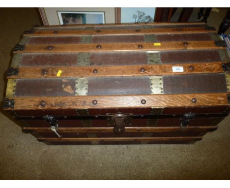 A Victorian wooden and metal bound dome topped trunk 