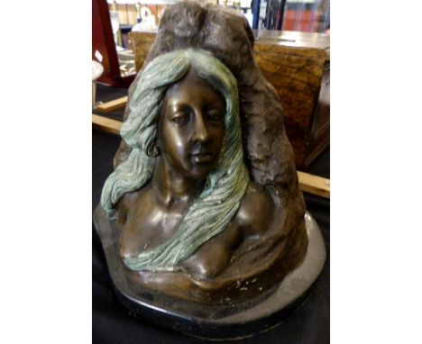 Bronze bust of a maiden leaning on a rock, on marble base