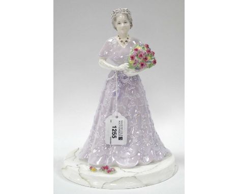 Coalport Sample Figurine of The Queen Mother in a Lilac Dress, holding a bunch of flowers, on a circular base.