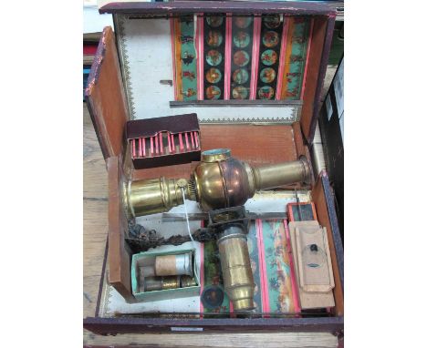 Early XX Century Brass Magic Lantern, possibly Triumph with a quantity of slides, in original (damaged) Marwan Morocco case.
