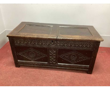 A XVII Century Joined Oak Coffer, with two panelled top and base with lozenge decoration, on stile feet.Cracks to panelled to