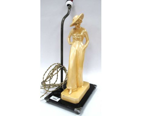 Art Deco Table Lamp of a Lady Wearing a Hat, mounted on a black glass base, 37cm high.