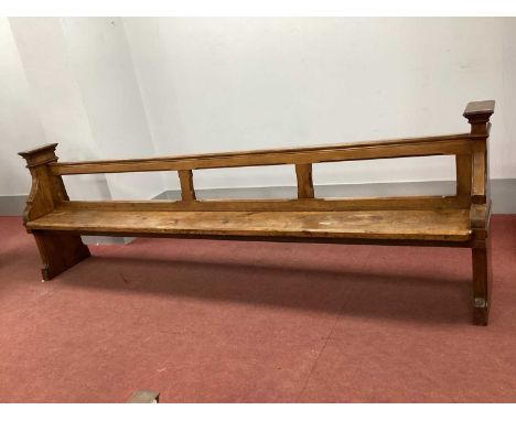 A XIX Century Pitch Pine Pew, with open back and shaped end supports, 295cm wide.