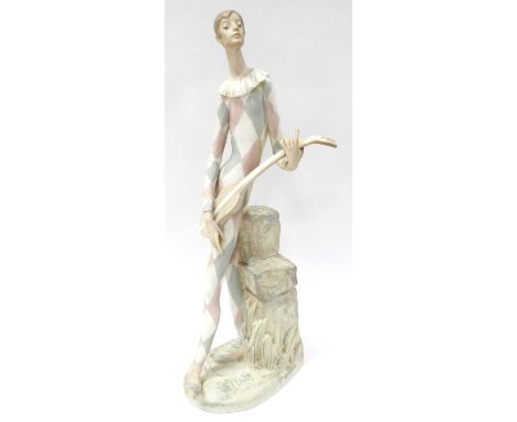 Lladro Figure of Harlequin With Lute Leaning on Rocks, in matt glaze, makers mark, impressed No 142, 47cm high