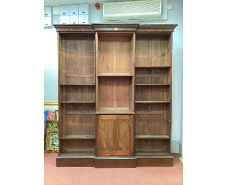 An Early XX Century Mahogany Breakfronted Bookcase, with stepped cornice, adjustable shelves and central panelled door on a p