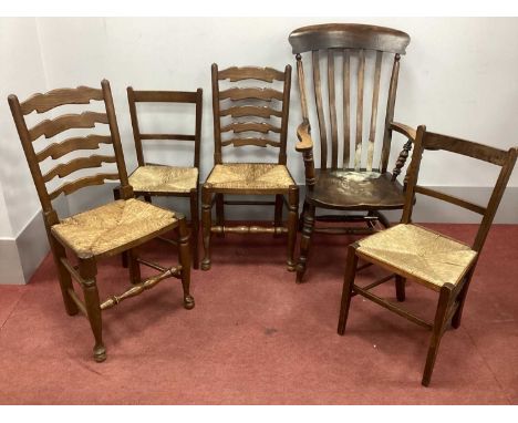 A XIX Century Ash and Elm Armchair; a pair of rush seated ladder back chairs and two bedroom chairs. (5)