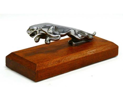 Jaguar Car Mascot, chrome finished 18.5cm long on oak plynth, 23cm overall.